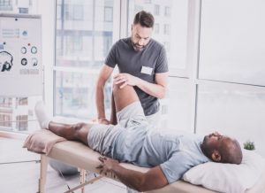 Physical Therapist With Patient
